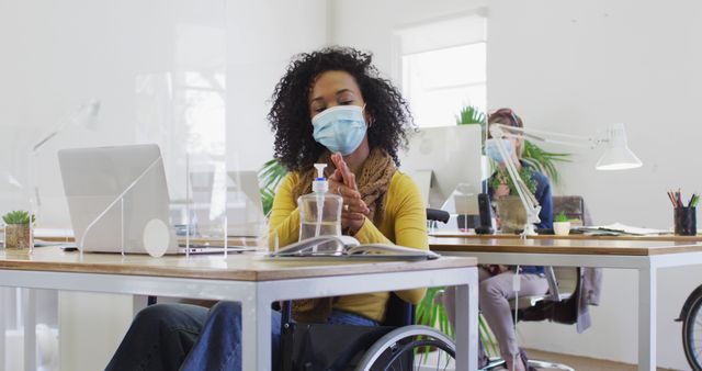 Disabled Woman in Wheelchair Using Hand Sanitizer in Office - Download Free Stock Images Pikwizard.com