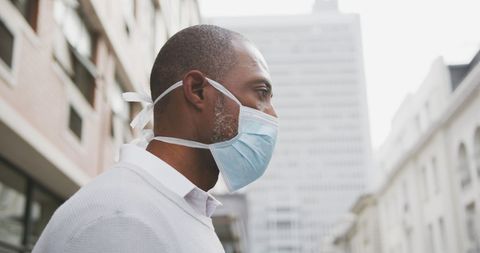 Man Wearing Face Mask in Urban Environment Against COVID-19