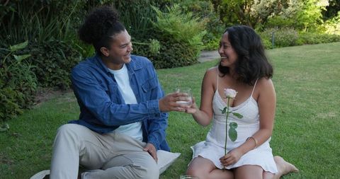 Couple Celebrating Love with Drinks at Outdoor Wedding