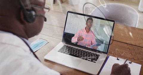 Senior professional conducting online mentoring session with young executive