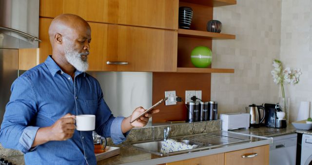 Senior Man with Tablet and Coffee in Modern Kitchen - Download Free Stock Images Pikwizard.com
