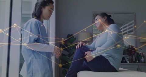 Nurse providing knee examination in clinical setting