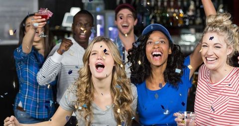 Diverse Friends Celebrating with Confetti in a Bar