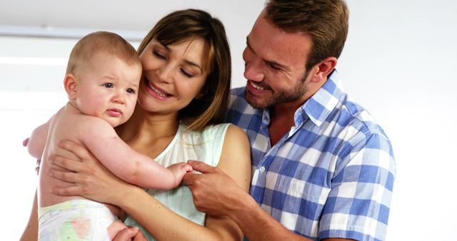 Happy Parents Holding Toddler in Their Home - Download Free Stock Images Pikwizard.com