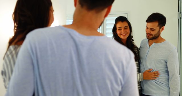 Expecting Couple Happy Together in Front of Mirror - Download Free Stock Images Pikwizard.com