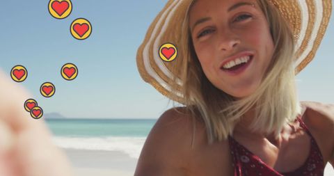 Cheerful Caucasian Woman Vlogging at Sunny Beach with Love Emojis