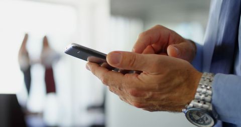 Businessman Using Smartphone Demonstrating Connectivity