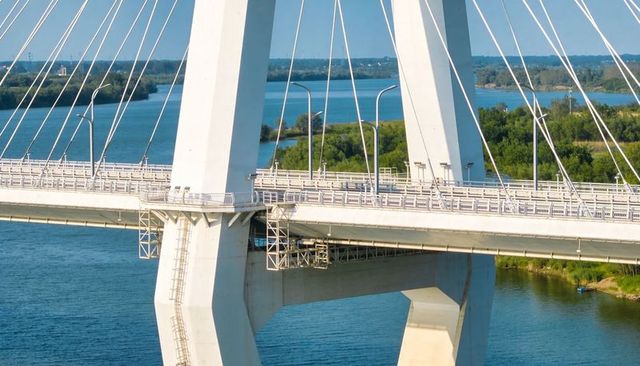Concrete Stay-Cable Bridge Pylon Supporting Roadway Deck over Blue River with Scaffold
