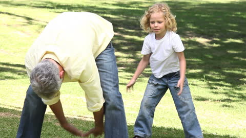 Father and Son Playing Encounters in Serene Green Park