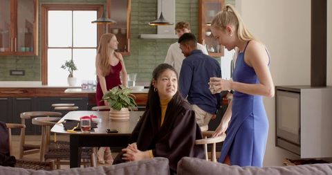 Multicultural Friends Socializing in Modern Sunlit Kitchen During Casual Gathering