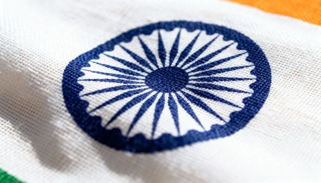 Macro ashoka chakra embroidery featuring indigo wheel and spokes on woven indian tricolor