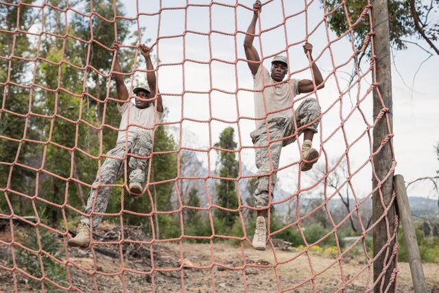 Military soldiers climbing a net during obstacle course - Download Free Stock Photos Pikwizard.com