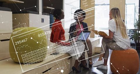 Diverse Businesswomen Innovating with Technology in Modern Office