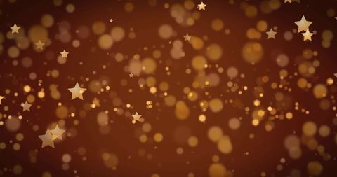 Gold starry bokeh on brown shimmering background