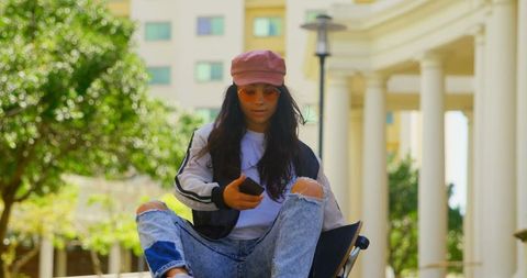 Trendy young woman skateboarding in urban area