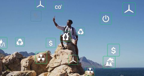 Man standing on rocky cliff surrounded by environmental icons