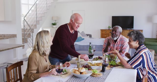 Senior Friends Enjoying a Festive Meal Together in Modern Home - Download Free Stock Images Pikwizard.com