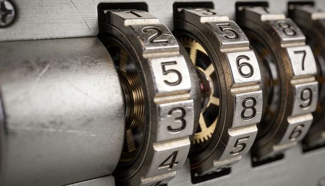 Macro rotating combination lock tumblers with exposed brass gears, mechanical precision