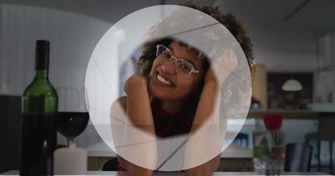 Cheerful woman enjoying virtual wine celebration