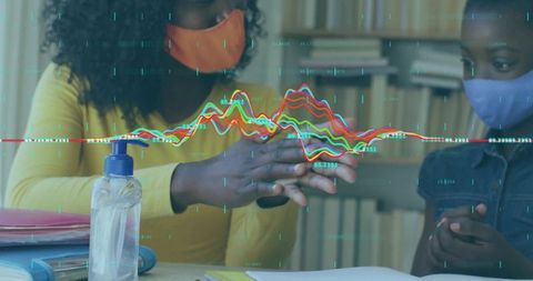 Mother and Daughter Ensuring Safety with Masks and Sanitizer