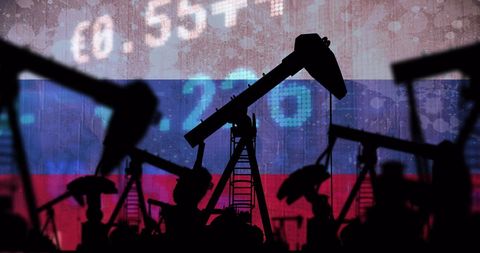 Silhouette of oil pump jacks over russian flag and financial data