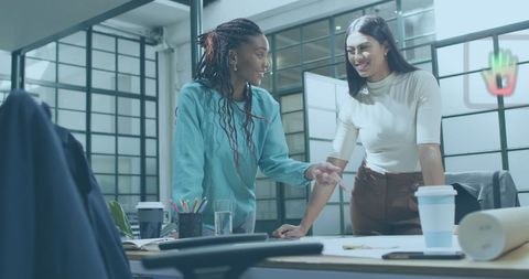 Female architects collaborating on project at modern workspace