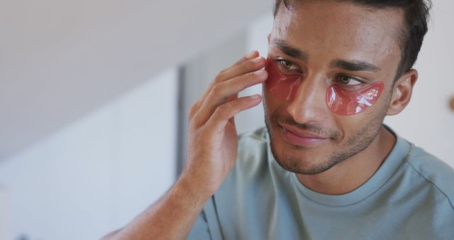 Man Applying Under-Eye Patches for Skin Care - Download Free Stock Images Pikwizard.com