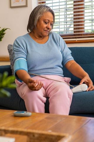 Senior woman home blood pressure monitoring