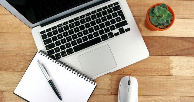 Modern Workspace with Laptop, Notebook, Mouse and Succulent Plant on Wooden Desk - Download Free Stock Images Pikwizard.com