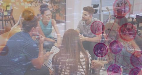 Diverse Team Engaged in Strategic Discussion with Network Graphic Overlay