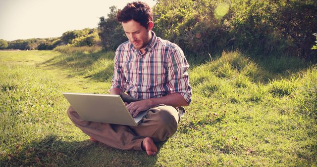 Man Working on Laptop Outdoors in Sunny Park - Download Free Stock Images Pikwizard.com