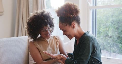 Joyful Moment Shared Same-Sex Female Couple Relaxing Home Sofa