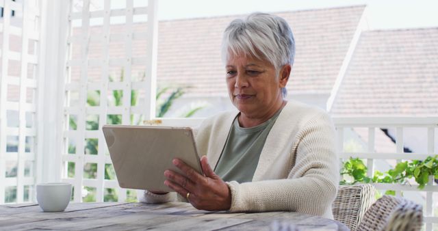 Senior Woman Using Tablet on Patio - Download Free Stock Images Pikwizard.com