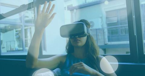 Woman Experiencing Virtual Reality on Sofa at Home