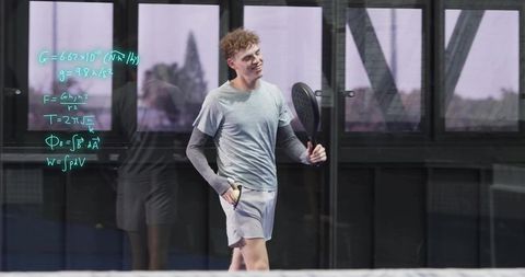 Smiling athlete holding padel racket walking glass court with teal equations and reflections