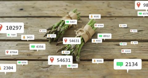 Asparagus bundles with digital notification icons on rustic table