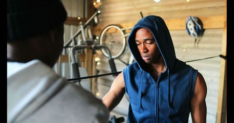 Boxer preparing for training with trainer in gym