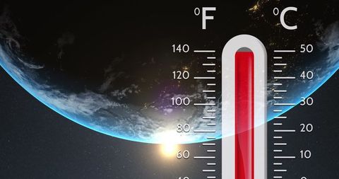 Rising global temperatures concept with earth and thermometer