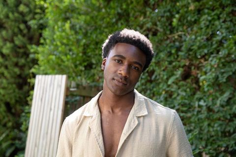 Relaxed Young Man Posing Naturally in Sunlit Garden