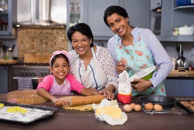 Three generations of women are baking together in a cozy kitchen, showcasing family bonding and happiness. Ideal for use in advertisements promoting family values, cooking products, or home appliances. Perfect for illustrating articles on family activities, recipes, or intergenerational relationships.