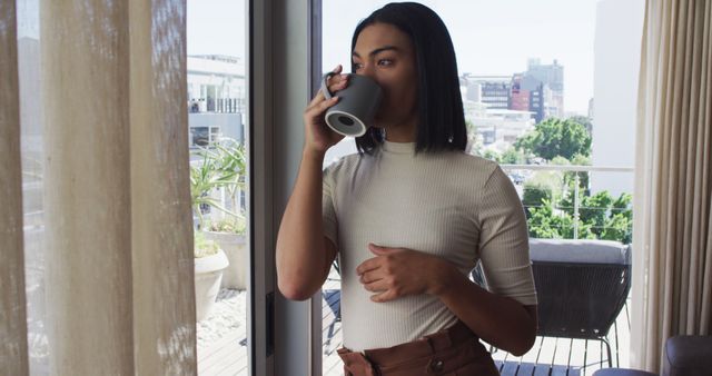 Woman Enjoying Coffee in Modern Apartment with Balcony View - Download Free Stock Images Pikwizard.com