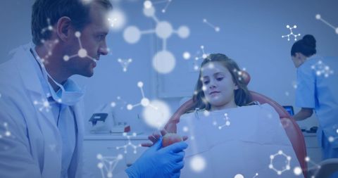 dentist wearing white coat and gloves holding an apple while talking to a young girl in a dental chair, with molecular structures visible. this concept image combines healthcare professionalism with scientific elements, showing innovation in dental practice. ideal for use in articles about modern dentistry, healthcare technology, or educational resources on dental health for children.