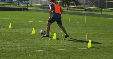 Soccer Training Drills with Player Dribbling Through Cones