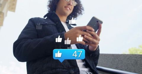 Young man checking social media likes on smartphone showing 47 likes blue notification