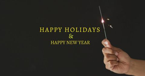Hand Holding Sparkler with Happy Holidays and New Year Message