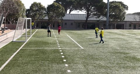 Youth soccer players practicing on artificial turf field