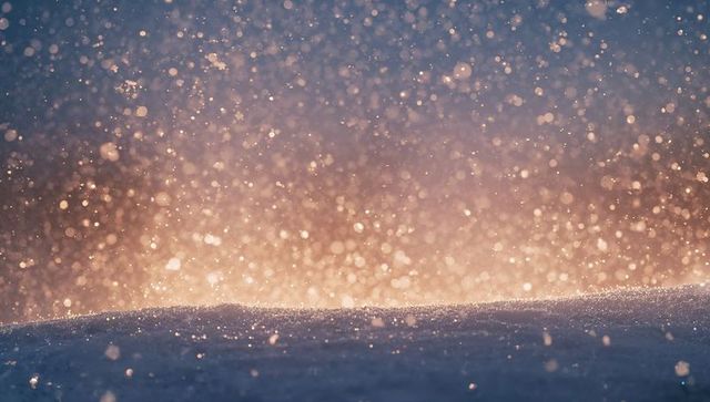 Glistening snow crystals falling at dawn with golden bokeh and backlit blue frost