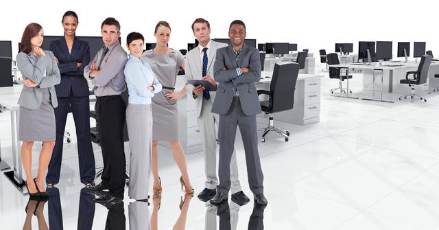 Group of diverse business professionals standing confidently in a modern open office workspace, showing strength, leadership, and teamwork. This can be used for business-related content, emphasizing concepts such as diversity, professionalism, corporate culture, and teamwork.