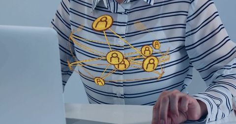 Mid-adult woman typing on laptop displaying golden network hologram visualization