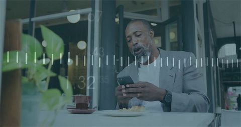 Businessman Checking Smartphone at Cafe with Digital Data Overlay and Coffee Break